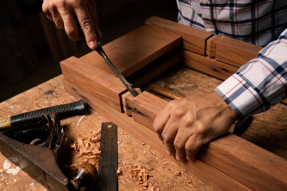 Woodworking hand tools resting on a custom furniture project